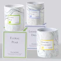 Three marble-textured soy candles in green, purple, and yellow labeled Floral Pear, Lavandula Dream, and Dancing Chamomile by Palmoire.