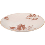 Ceramic serving plate with terracotta leaf impressions on cream background and speckled texture.