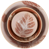 Nested ceramic bowls with rust-red leaf motifs in varying sizes, arranged concentrically on a white background.