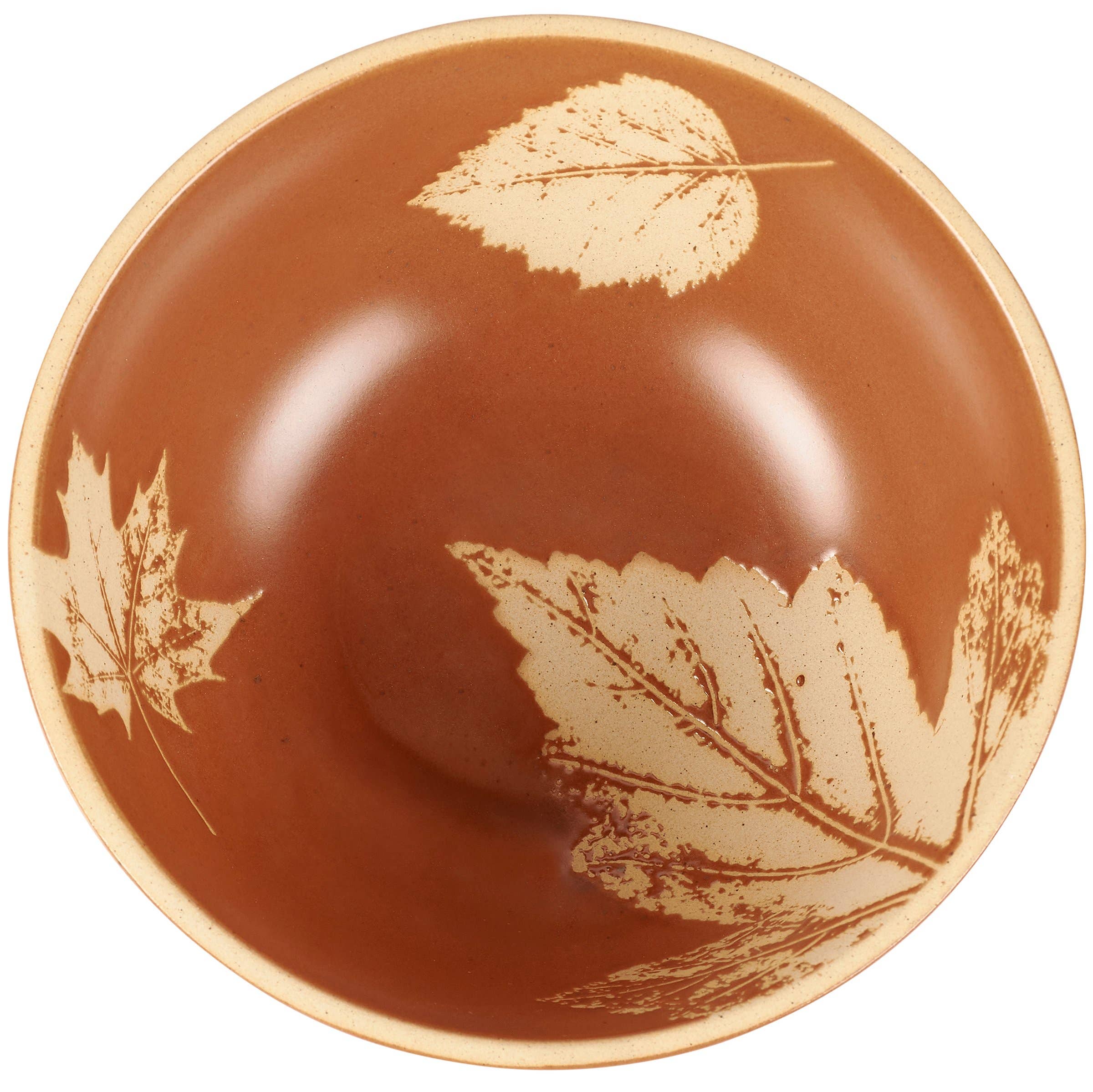 Terracotta bowl with cream-colored leaf etchings including maple and fern designs on a glossy brown ceramic surface.