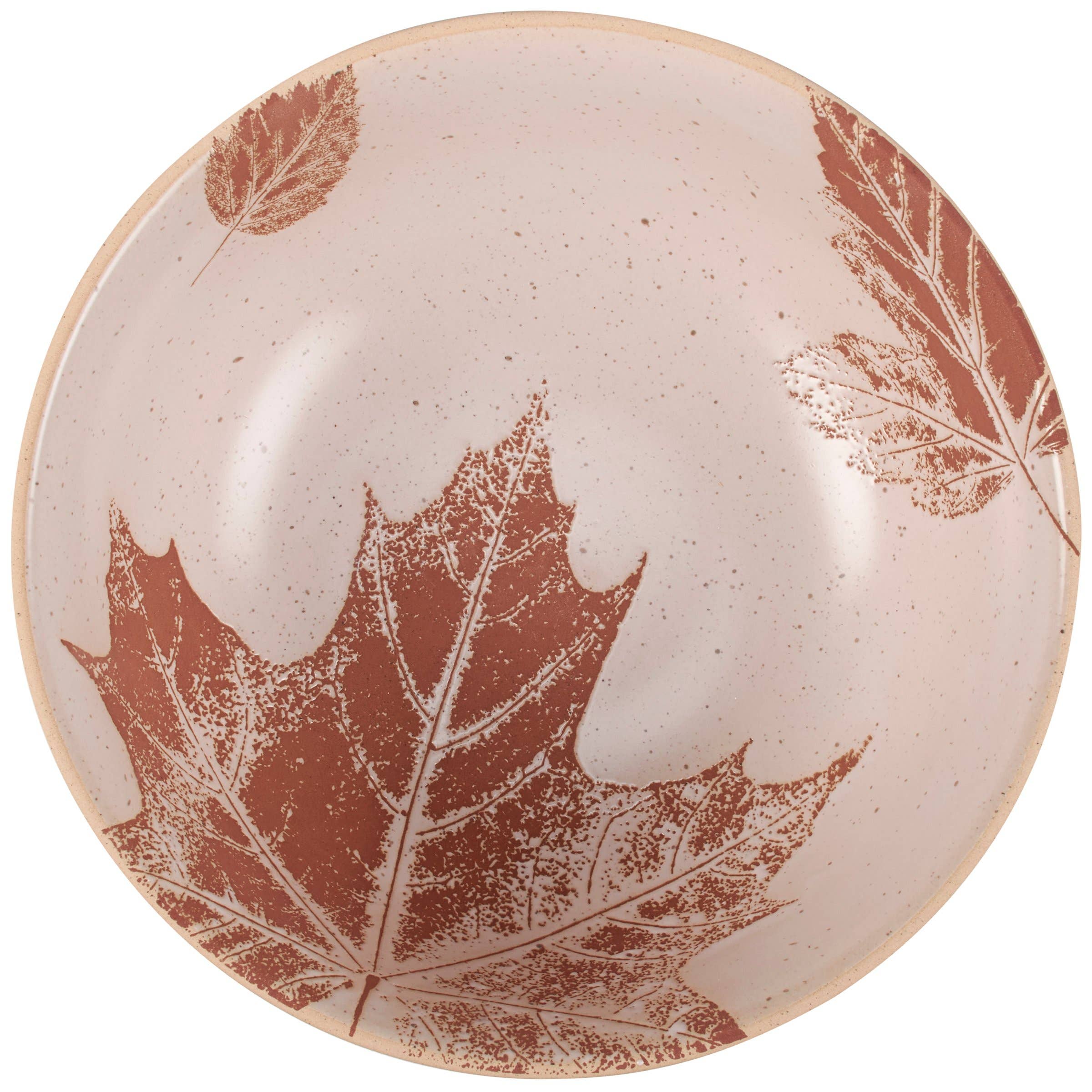 Cream ceramic bowl with rust-colored maple leaf imprints and delicate botanical details.