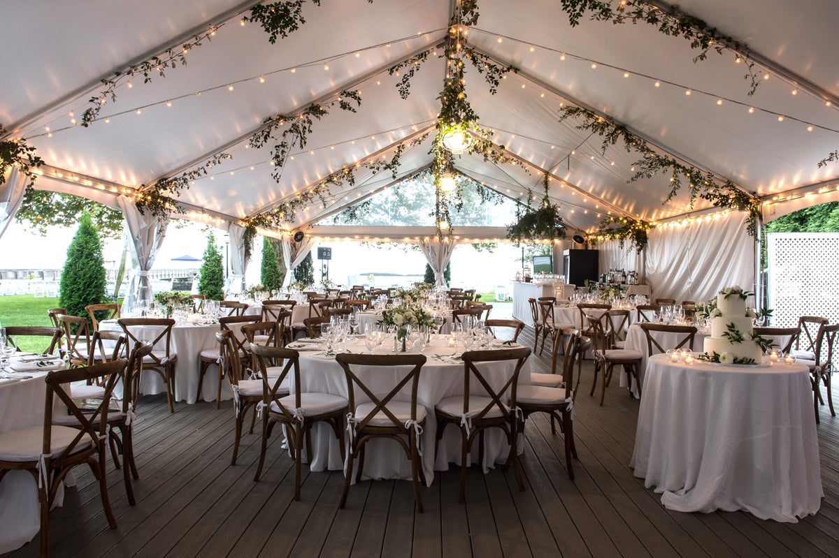 Wedding tent installation with hanging greenery and string lights designed by The Flower Bar, Westchester County wedding florist